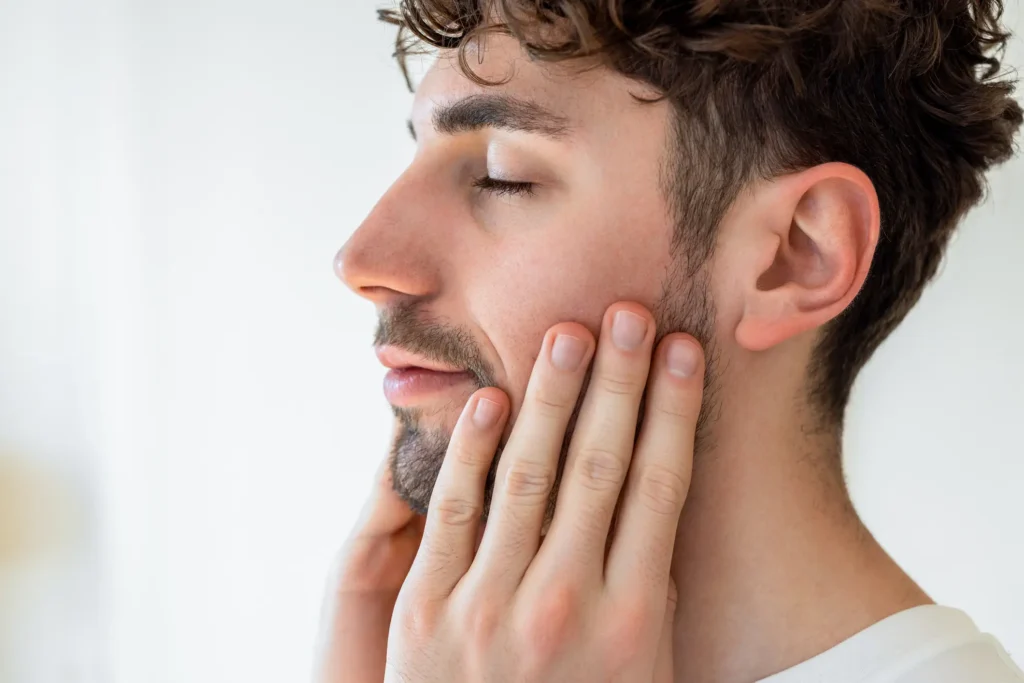 Man with hands on cheeks